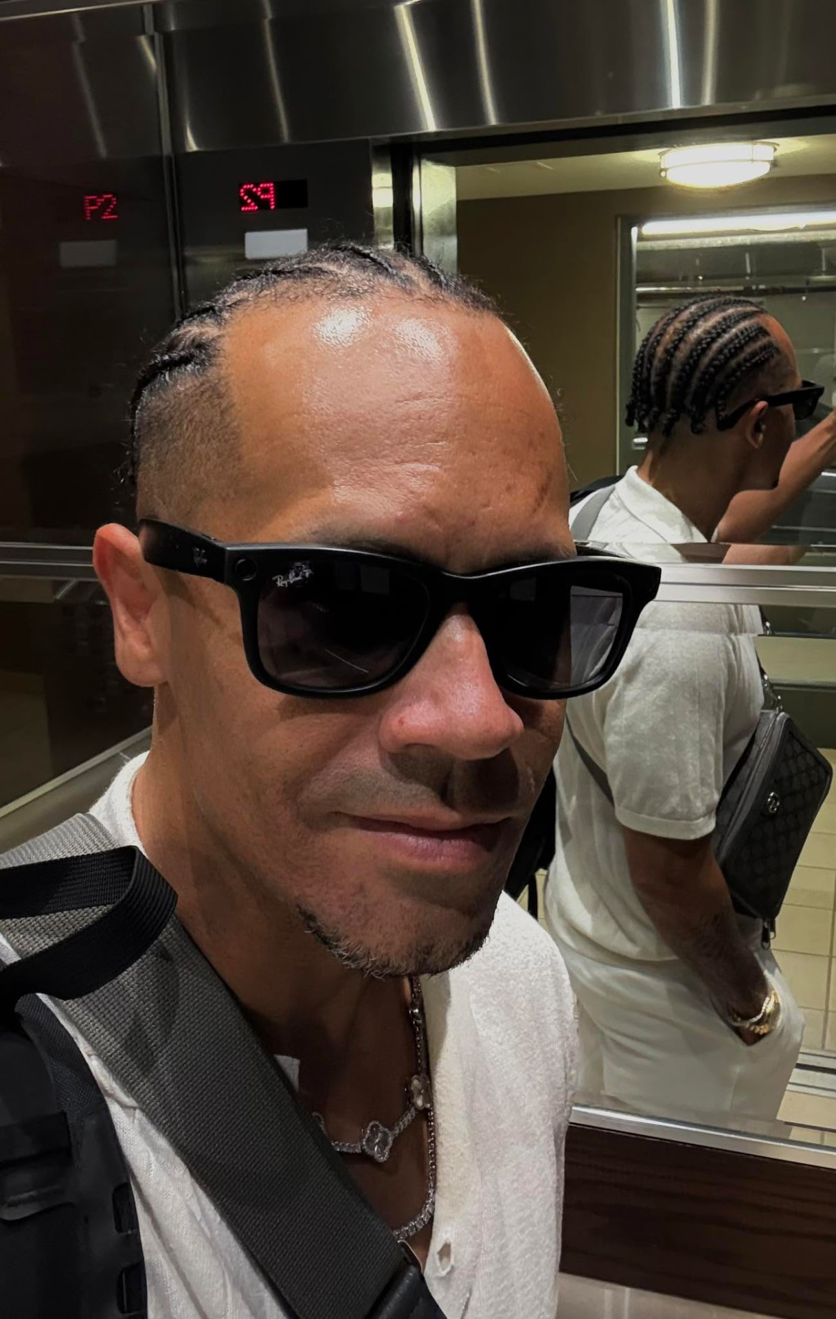 J.R. in sunglasses travelling between cities